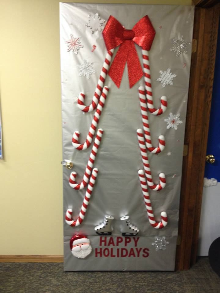 a door decorated with candy canes and santa hat