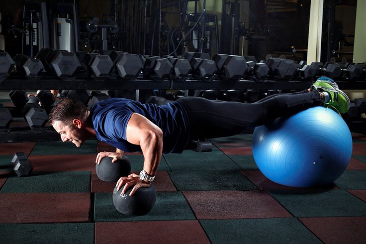 a man is doing push ups on an exercise ball