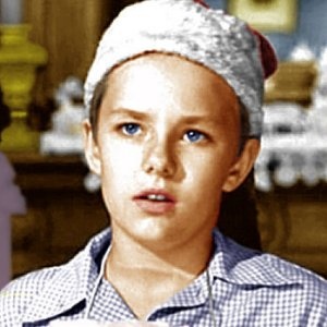 a young boy wearing a santa claus hat