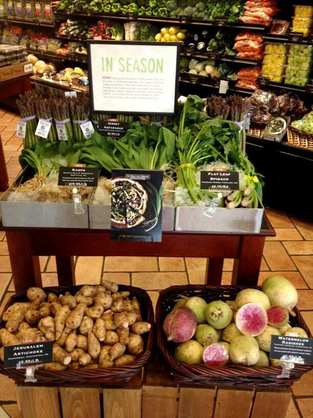 the produce section of a grocery store with fresh fruits and vegetables on display in baskets