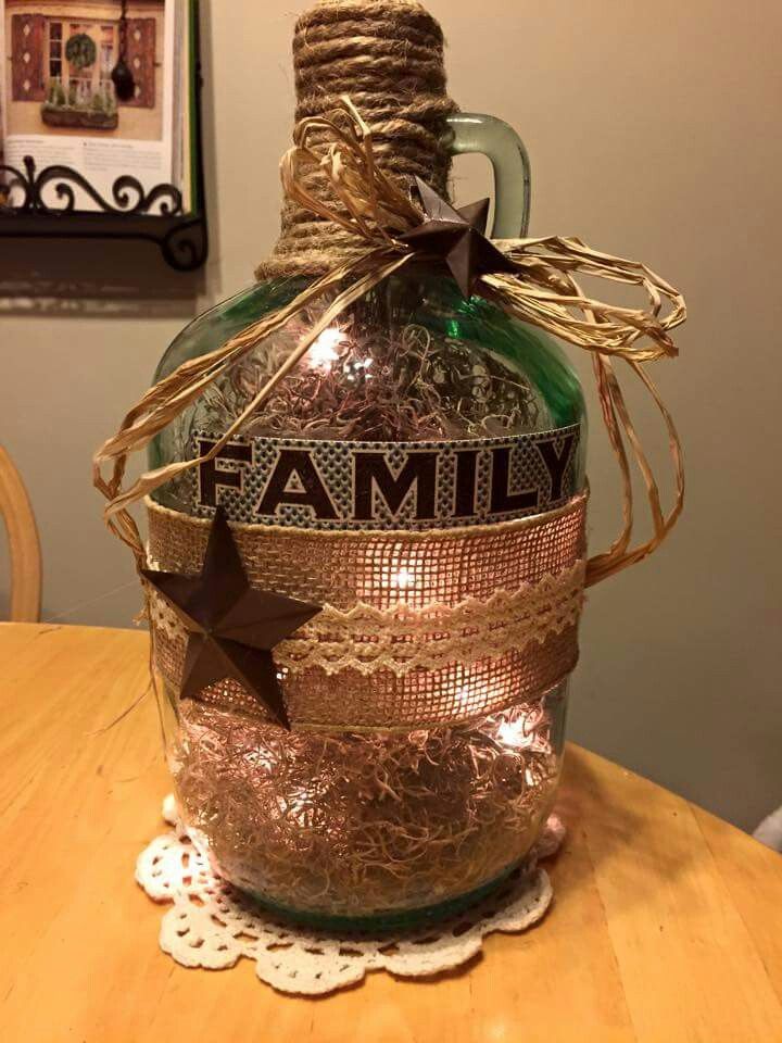 a glass bottle with the word family on it sitting on top of a wooden table