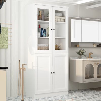 a bathroom with white cabinets and tile flooring