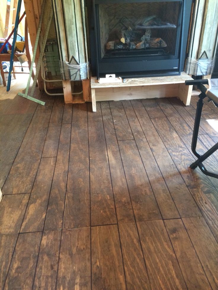 a living room with wood floors and a fire place