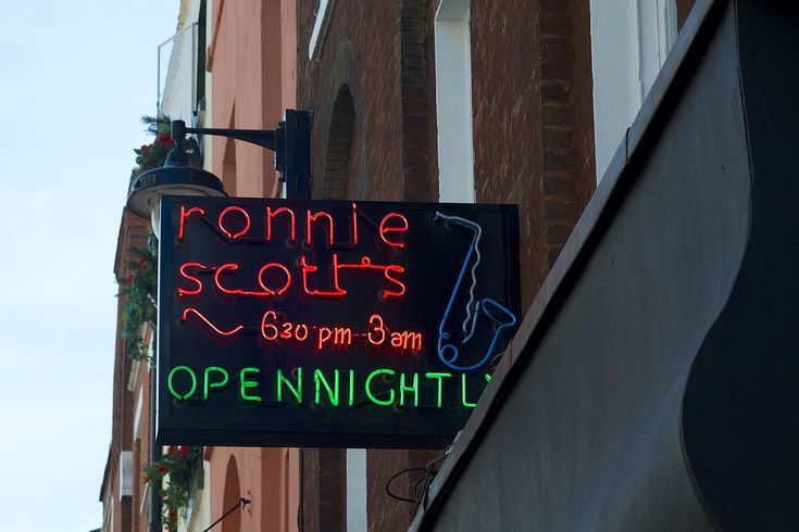 a neon sign on the side of a building that says bonnie scott's open nights