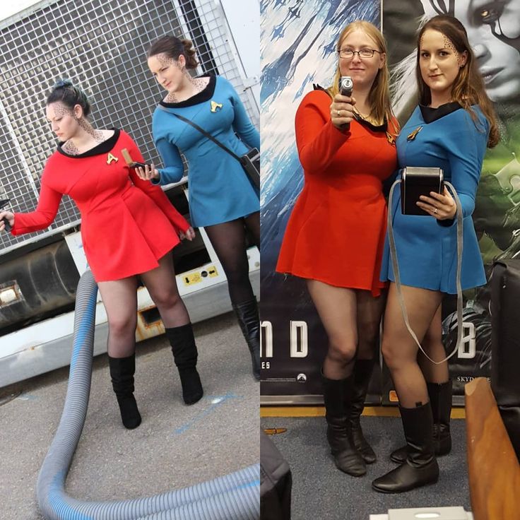 three women dressed as star trek cosplayes standing in front of a movie poster