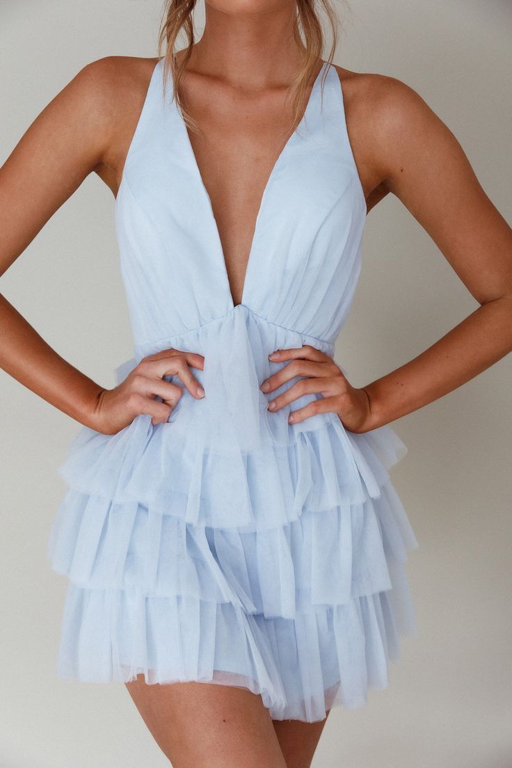 Sky blue mini dress Lined Plunging neckline Tiered frill bodice Criss-cross back Zipper in back You will steal the show in our gorgeous Auguste mini dress. Featuring a plunging neckline and tiered frill bodice. Wear it to a bachelorette or a special birthday celebration. Team it with nude heels and a clutch for a look that'll have you flooded with compliments. MODEL INFO Model is wearing size XS Height: 5'7" Bust: 32" Waist: 24" Hips: 34" SIZE INFO Flat garment measurements This was manually mea Light Blue Mini Dress With Ruffled Straps For Party, Flirty Light Blue Mini Dress With Ruffles, Elegant Blue Tulle Mini Dress, Blue Tiered Mini Dress With Ruffle Hem, Light Blue V-neck Mini Dress With Ruffles, Frill Mini Dress, Yellow Bridesmaid Dresses, Purple Bridesmaids, Yellow Bridesmaids