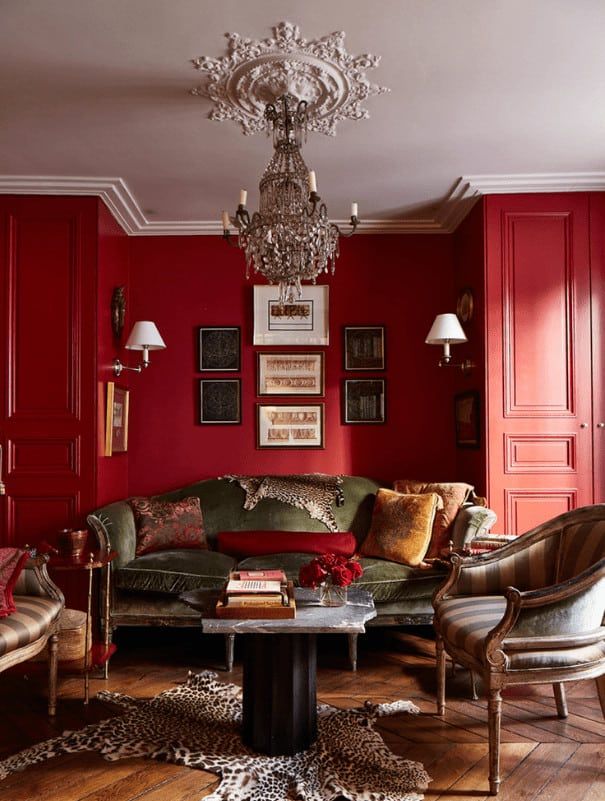 a living room filled with furniture and red walls