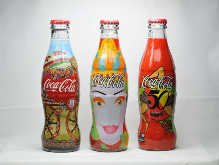 three different types of coca cola bottles on a white background, each with an individual's face painted on the bottle