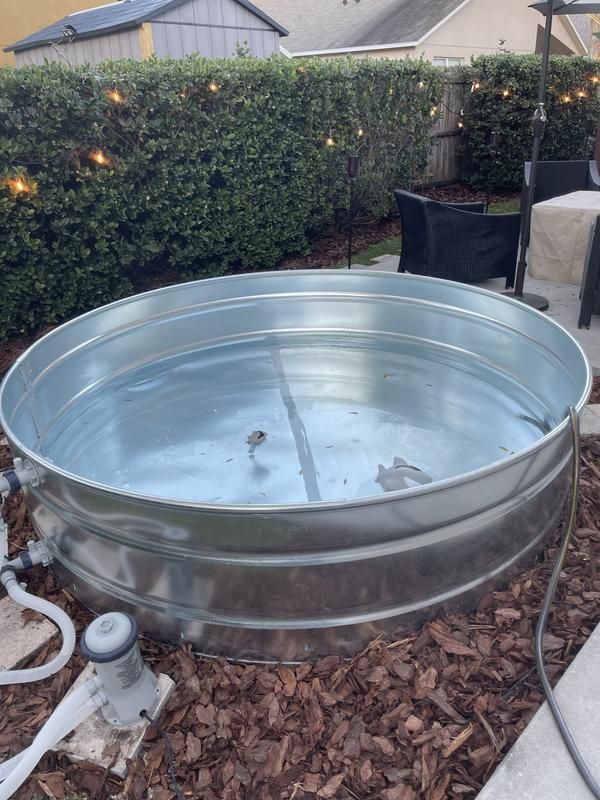 a large metal tub sitting in the middle of a yard