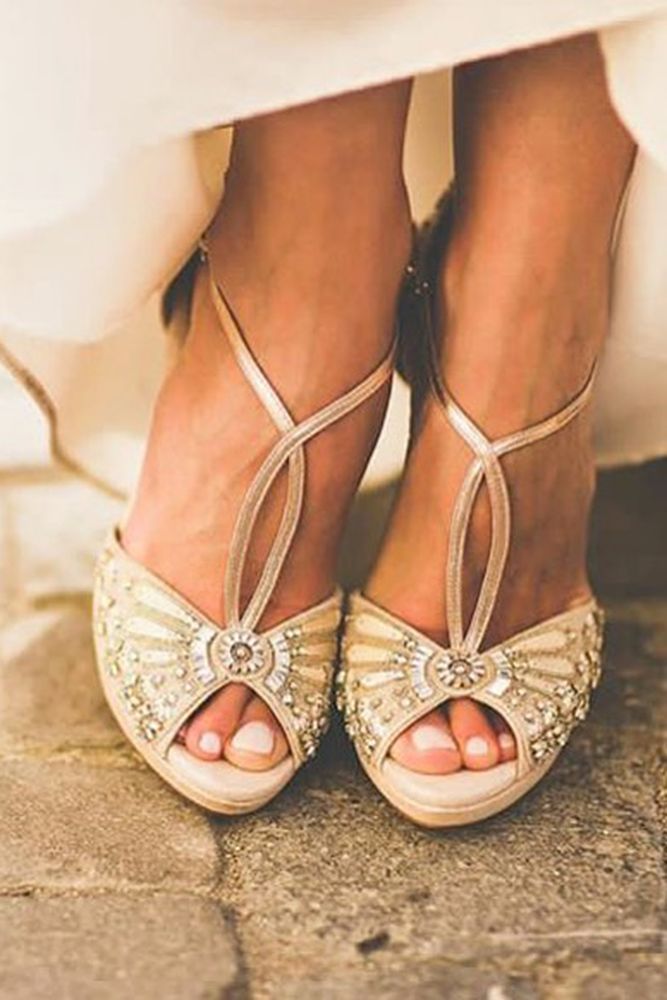 the bride's shoes are adorned with jewels