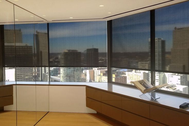 an office with large windows overlooking the city