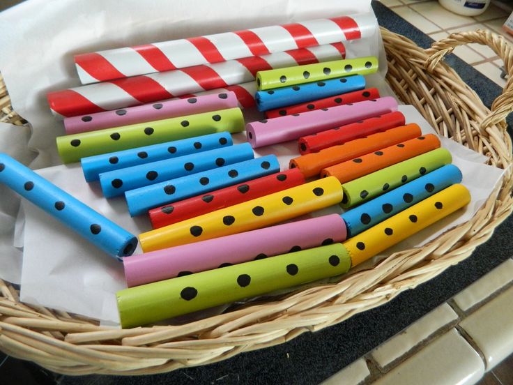 a basket filled with colorful wooden flutes sitting on top of a counter