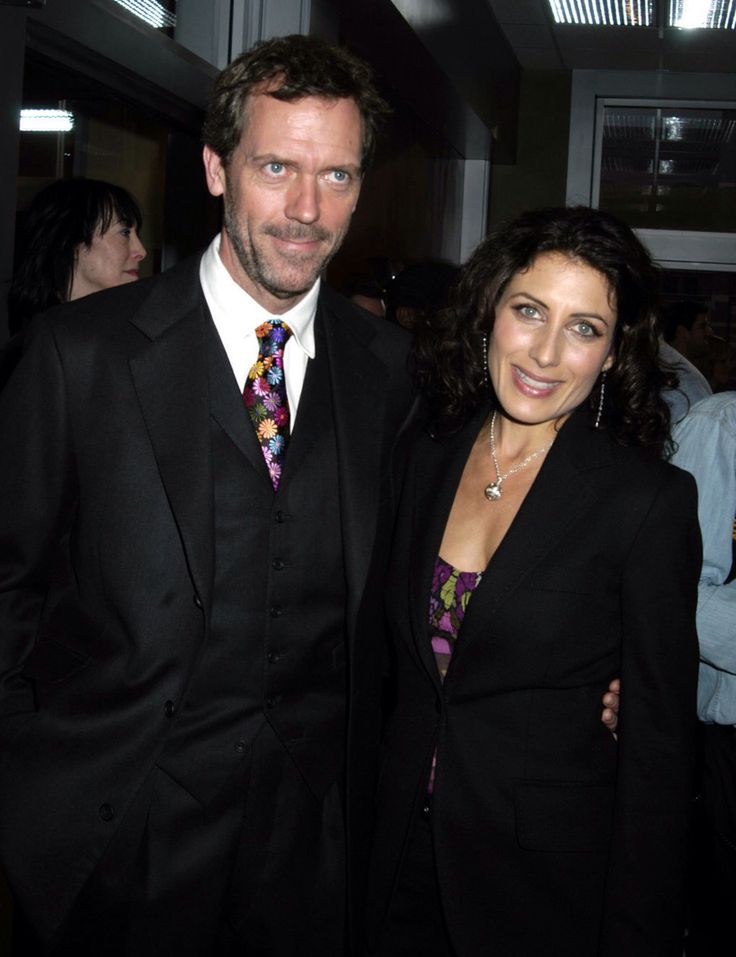 a man in a suit and tie standing next to a woman