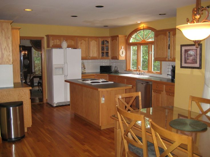 a kitchen with wooden floors and white appliances