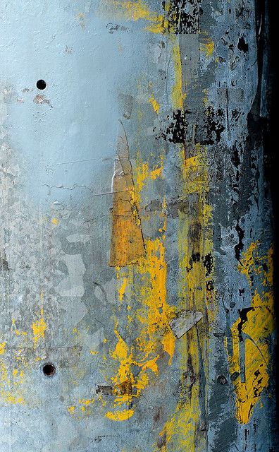 an abstract painting with yellow and blue colors on the outside, including paint chippings