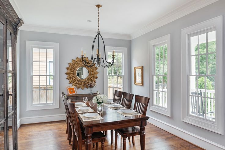 a dining room table with chairs and a chandelier