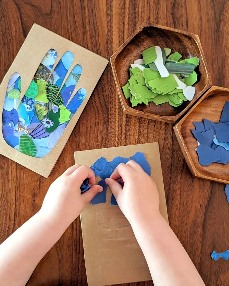 a child is making crafts with blue and green paper