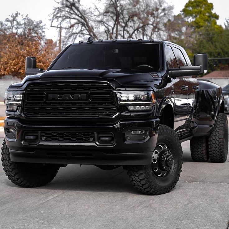 a large black truck parked in a parking lot