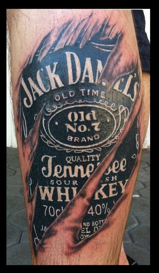 a man's leg with an old time whiskey label tattoo on it, and the words jack daniels sold times