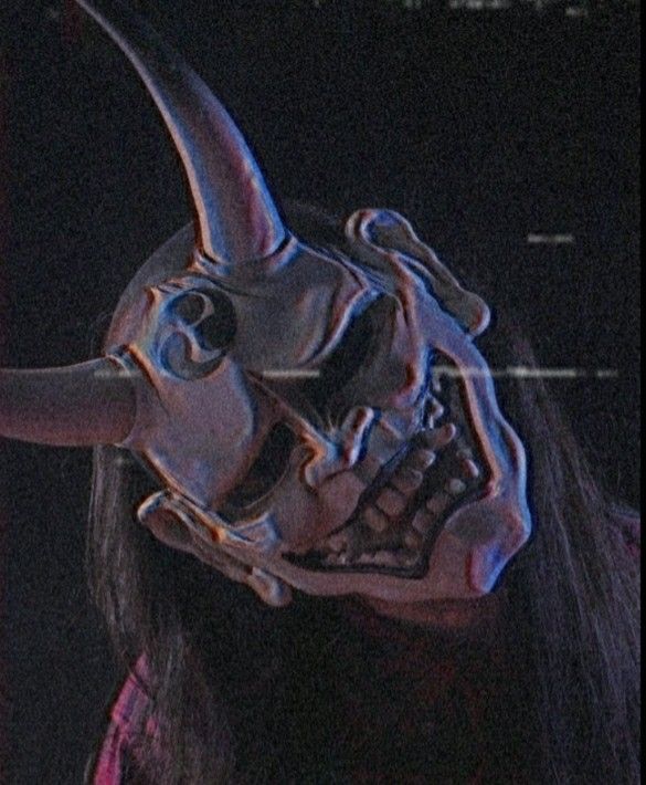 a person with a mask on their face and an animal's head in the background