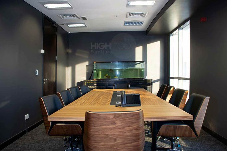 an empty conference room with chairs and a large wooden table in the middle of it