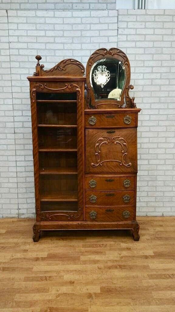 an old wooden dresser with a clock on top