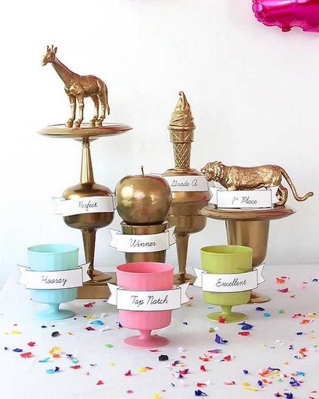 a table topped with lots of different types of cupcakes and cake toppers