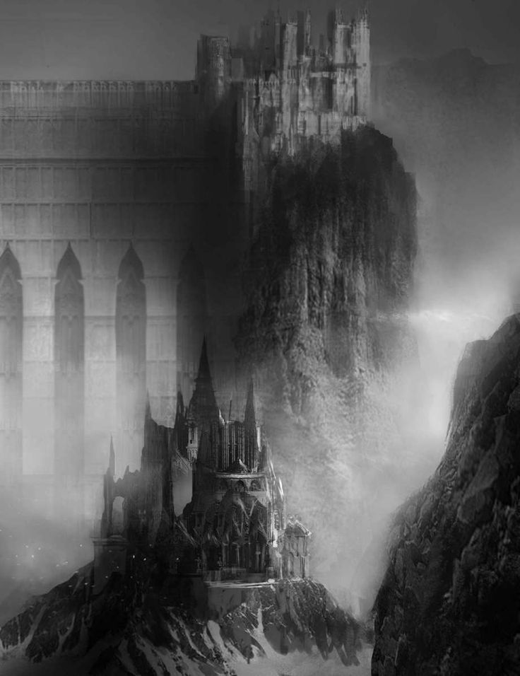 an artistic black and white photo of a castle on a mountain top with fog in the air