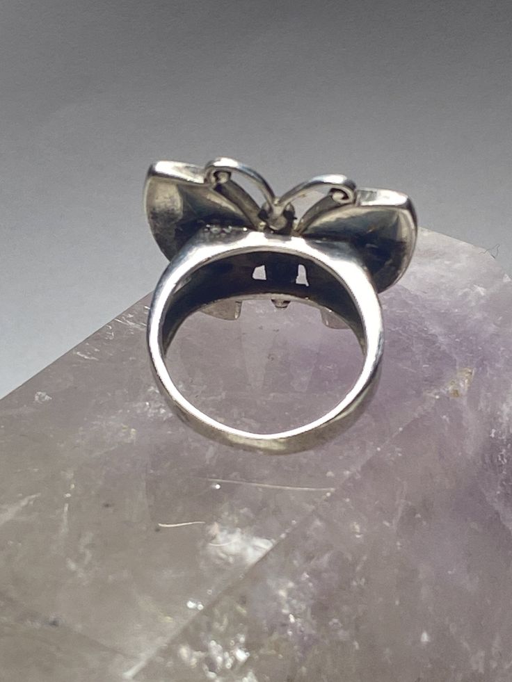 "Butterfly ring mother of pearl sterling silver women girls Size 6.75. Between a size 6.75 and a size 7 Length 7/8\" Width 1\" Thinnest 5/32\" Free Shipping & Free Postal Insurance Delivered in a Gift Box If you do not want the ring polished and want to leave the natural patina please let me know at the time of purchase as I do polish rings before I ship rings out. Thanks Free First Class shipping and postal insurance is included. If you want to upgrade to priority kindly pay an additional f Formal Sterling Silver Moonstone Ring, Fine Jewelry Silver Hallmarked Moonstone Ring, Nickel-free Ring For Mother's Day, Polished Finish Pearl Ring As Gift, Classic Silver Butterfly Ring For Anniversary, Silver Opal Ring With Inlay, Silver Ring Jewelry For Mother's Day, Vintage Flower Ring For Formal Occasion, Formal Vintage Flower Ring