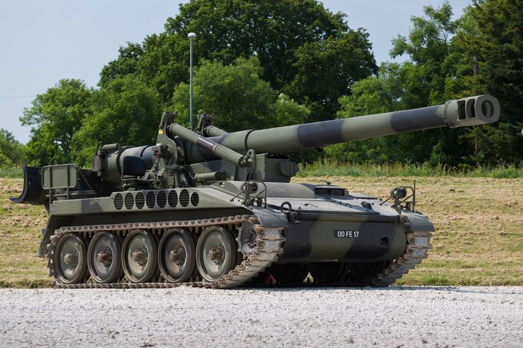 an army tank is parked on the side of the road