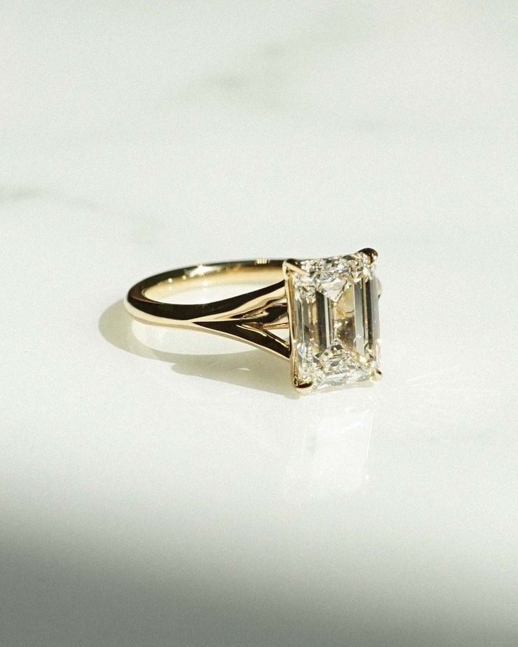 a diamond ring sitting on top of a white table