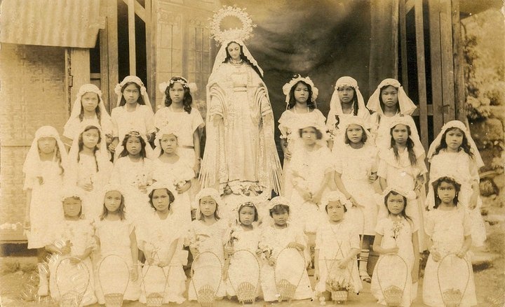 an old photo of a group of women in white dresses