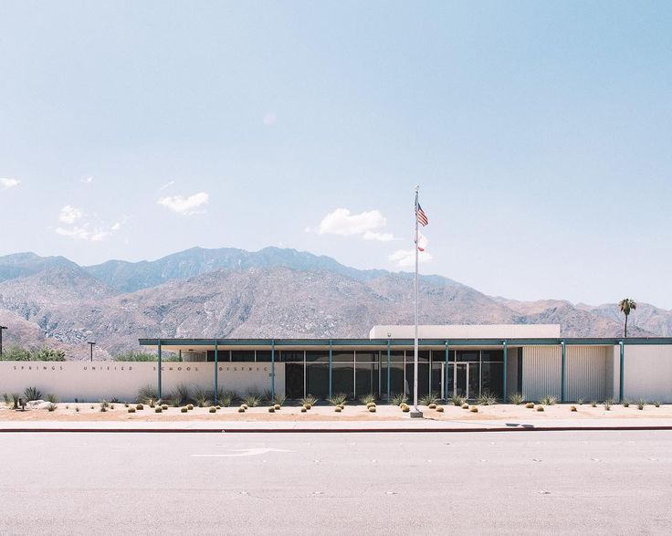 a building with mountains in the background