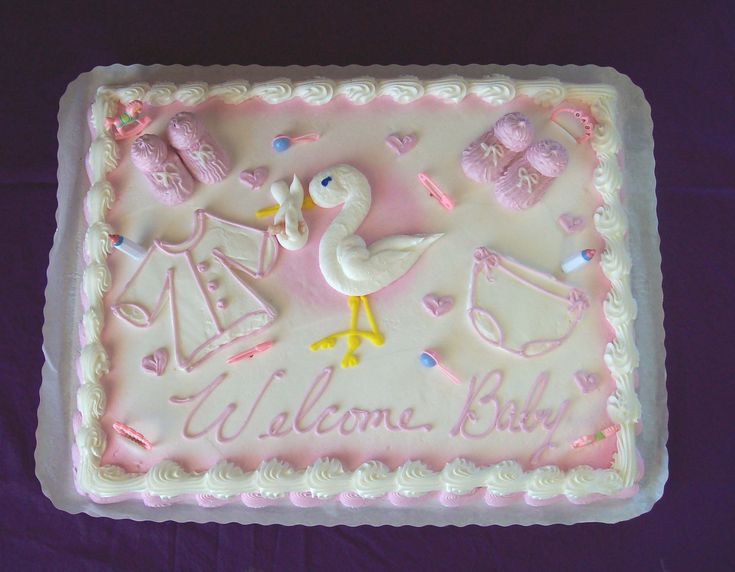 a baby shower cake on a purple table cloth