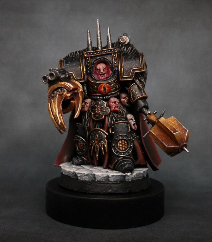 a miniature warhammer is standing on a black surface