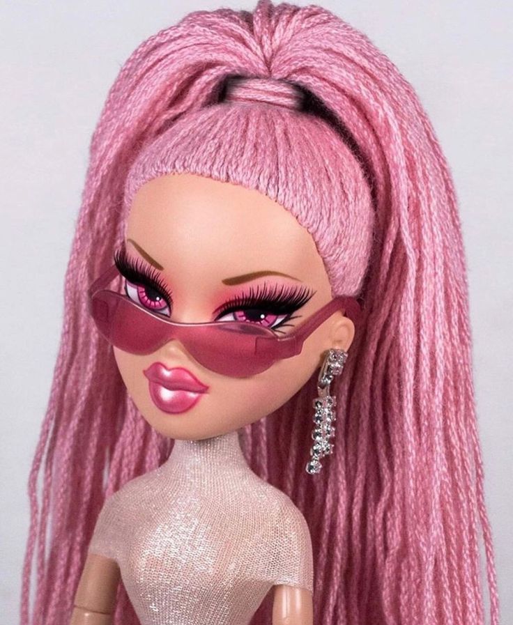 a doll with pink hair and sunglasses on