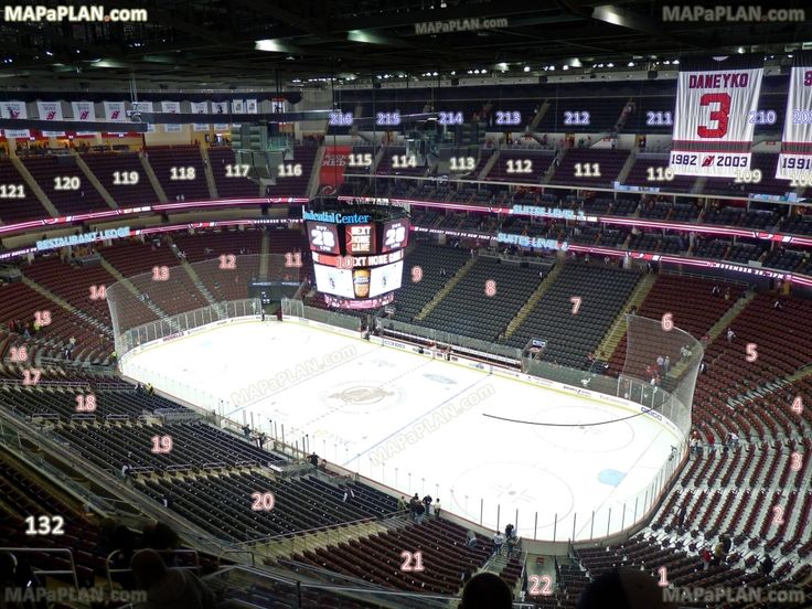 an ice hockey arena is shown with the scoreboard and seats highlighted in pink letters