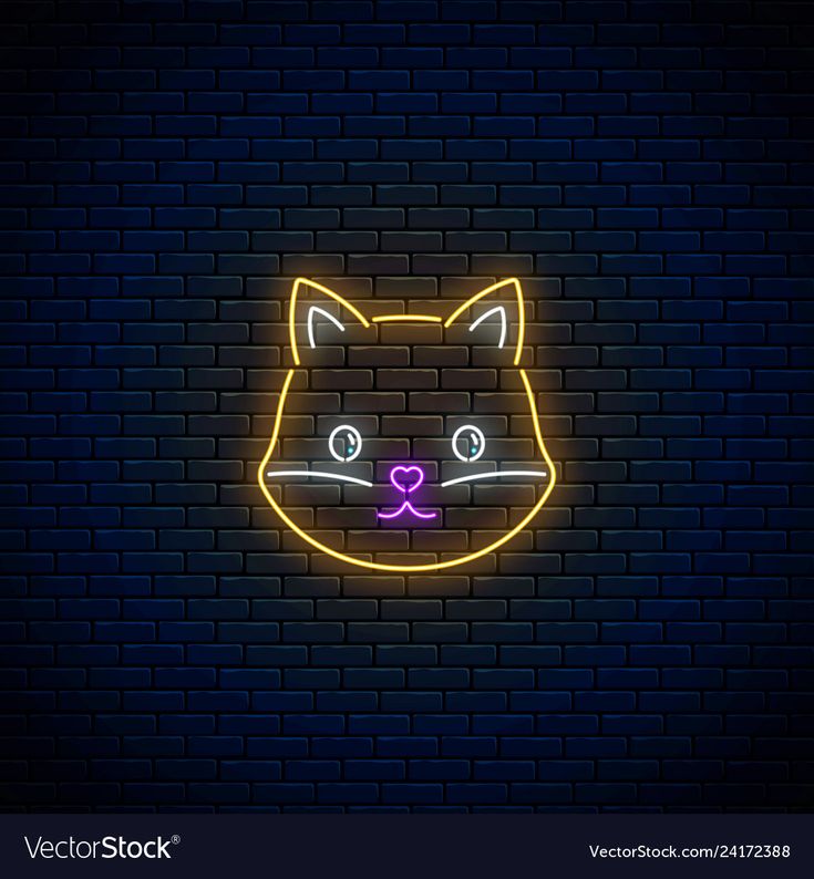 a neon cat face on a brick wall