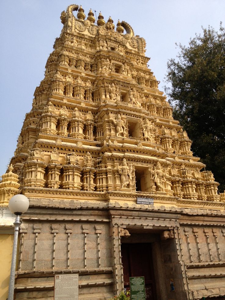 an ornately carved temple with trees in the background