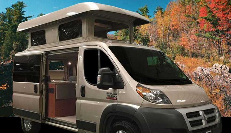 an advertisement for a camper van parked in front of some trees with fall colors