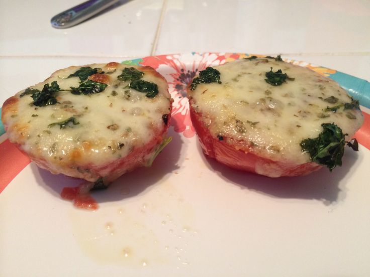 two stuffed meats with cheese and spinach on a plate next to a fork