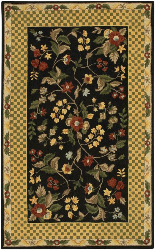 a black rug with flowers and leaves on the bottom, in front of a checkered background