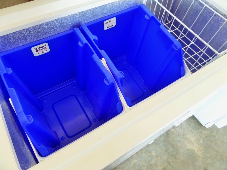 two blue bins sitting in the middle of a white counter top next to each other