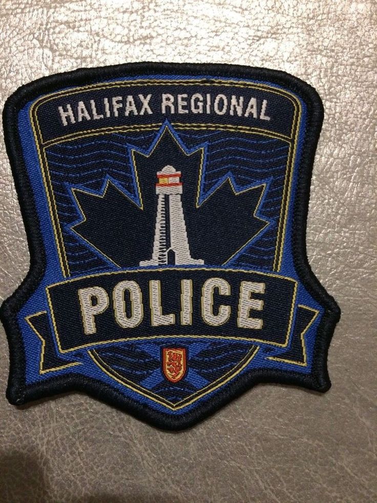 the halifax regional police badge is displayed on a wall in front of a metallic surface