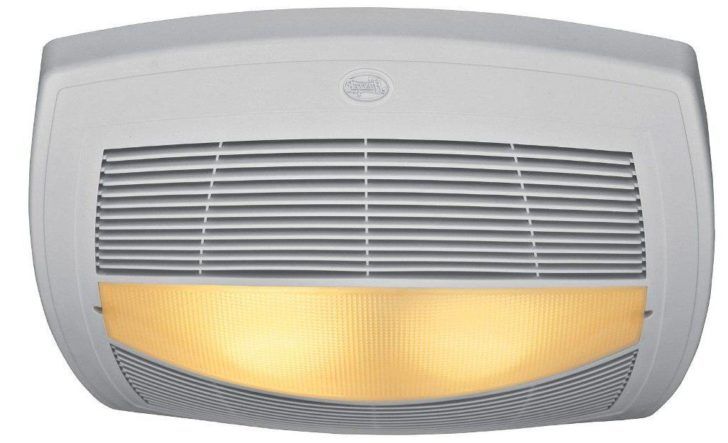 a light that is on the side of a white wall mounted heater with an orange light