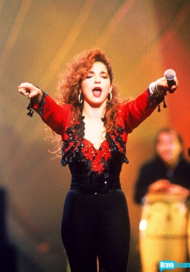 a woman with red hair is singing on stage