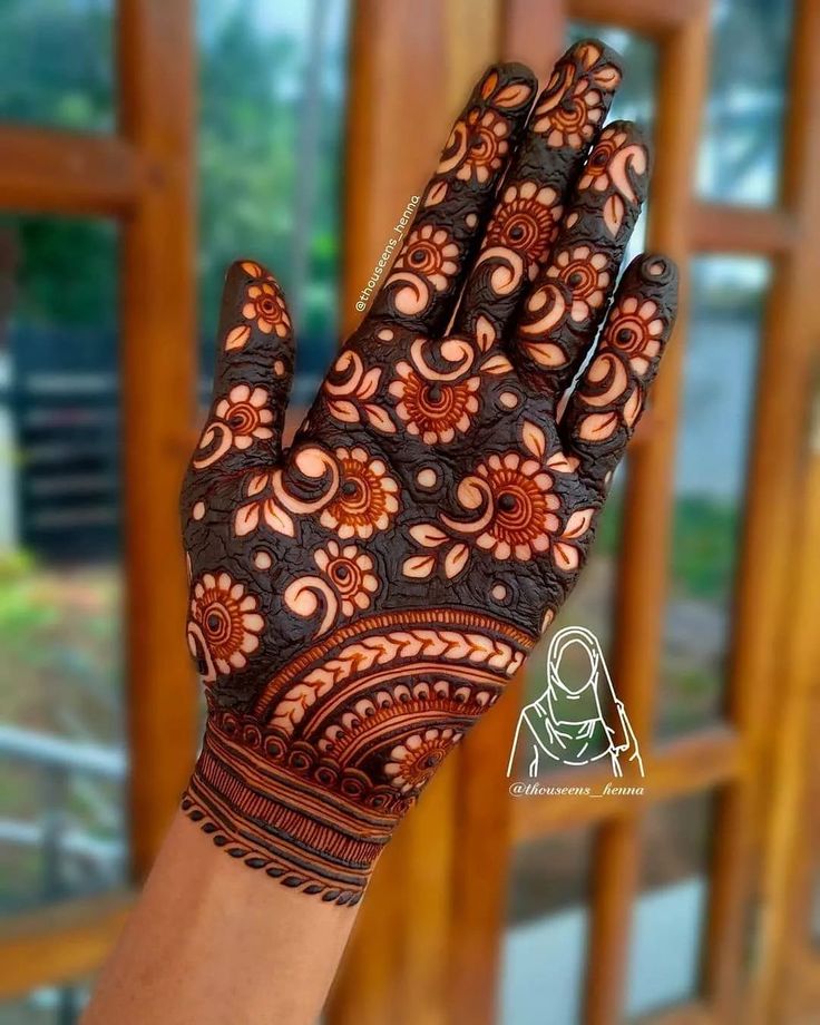 the hand is decorated with henna designs and has an intricate design on it's palm