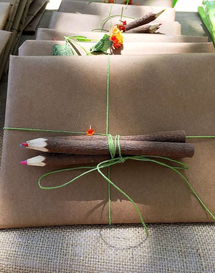 an envelope wrapped in brown paper and tied with green twine on top of it