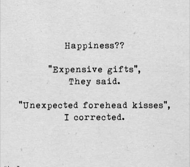 an old typewriter with the words happiness? expensive gifts, they said unexpected forehead kisses, i corrected