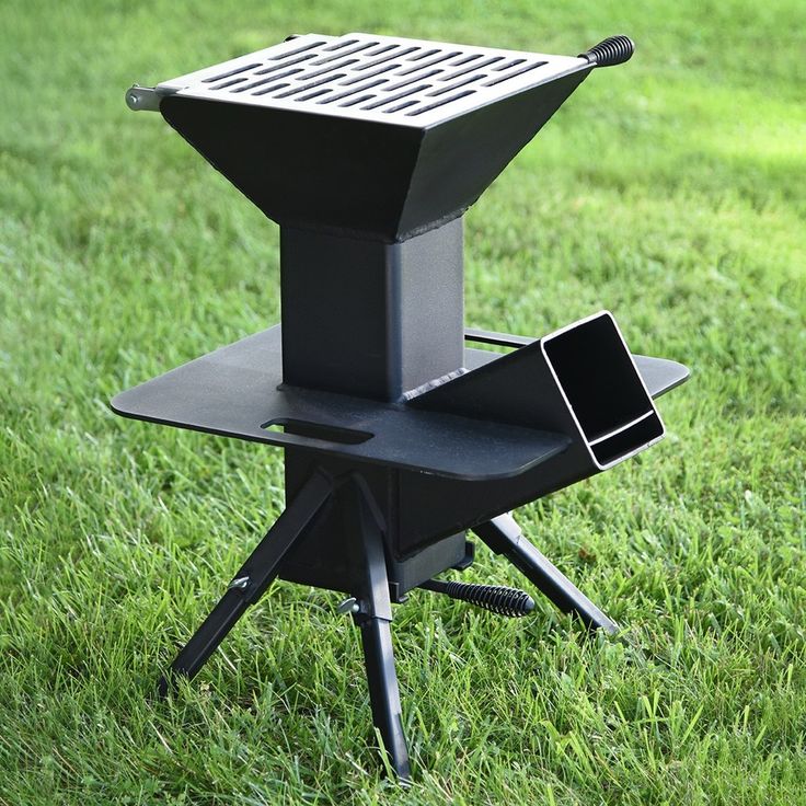 an electronic device sitting on top of a black stand in the middle of some grass